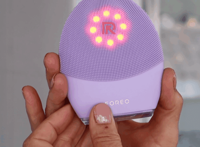 Foreo Luna 4 device next to skincare essentials